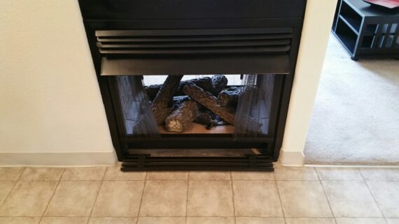 A black gas fireplace in a home to illustrate gas fireplace safety tips